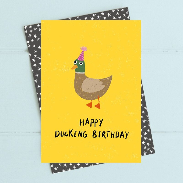 yellow birthday card with a silly duck drawing wearing a pink birthday card. bottom text reads "happy ducking birthday"