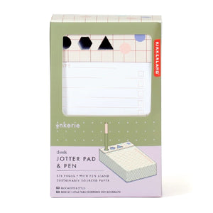 green and purple rectangular package on a white background. a panel reveal bullet-point lined paper and a pen holder with three holes: a circle, a hexagon, and a triangle. kikkerland product