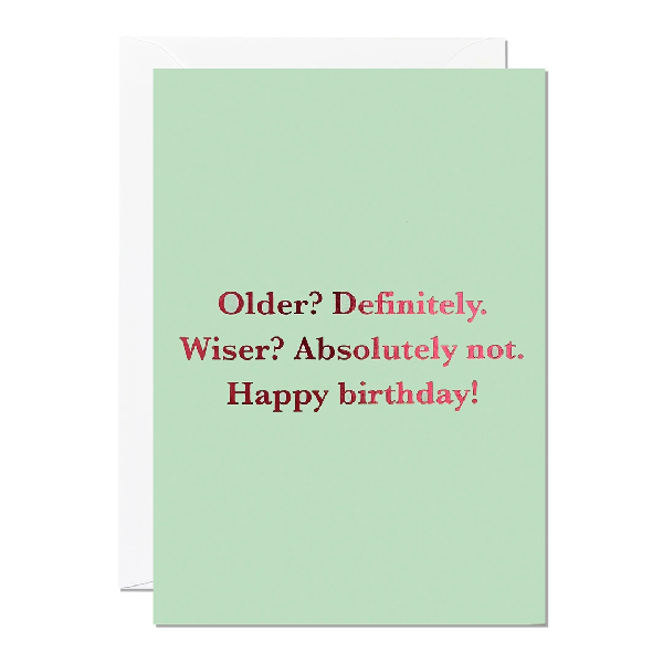 pale green birthday card. reflective pink middle text reads "older? definitely. wiser? absolutely not. happy birthday!"