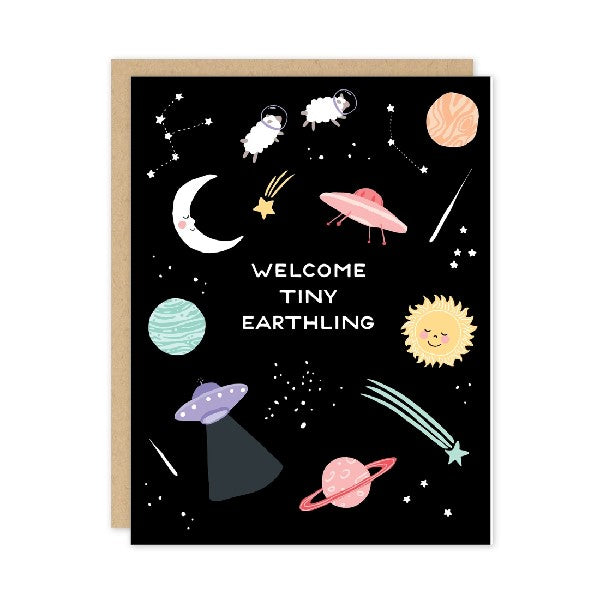 black galaxy baby card. smiling planets, UFOs, stars, and helmet-wearing sheep are illustrated around white text. centre text reads "welcome tiny earthling"
